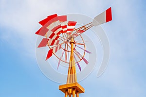 Colorful weathervane over the blue sky background.