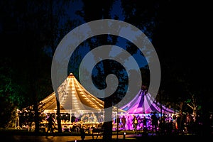 Colorful wedding tents at night. Wedding day