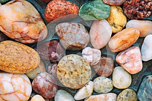 Colorful wet pebbles on the beach.