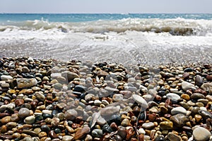 Colorful wet pebbles on sea beach
