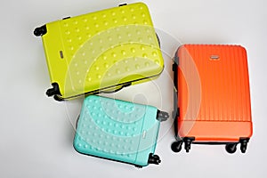 Colorful wheeled suitcases, top view.