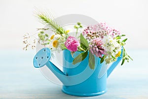 Colorful wildflowers in watering can