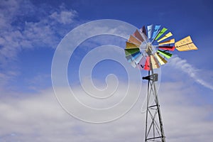 Colorful wind mill isolated on blue sky