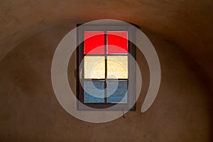 Colorful Window Glass in Masked Red Yellow and Blue in Cellar