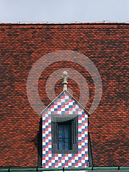 Colorful window on tiled roof