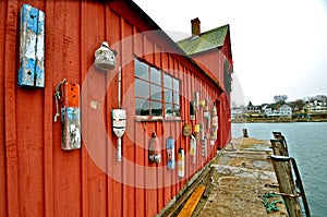 Colorful wood buoys hang on shack