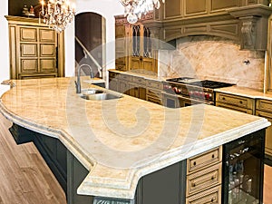 Colorful wood kitchen cabinets with appliances, granite countertops and hardwood floor