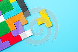 Colorful wood puzzle pieces on blue background, geometric shape block. Concepts of logical thinking, Conundrum, solutions,
