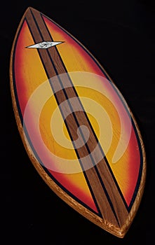 Colorful wood surfboard, black background