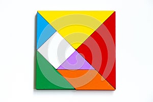 Colorful wood tangram puzzle in square shape on white background