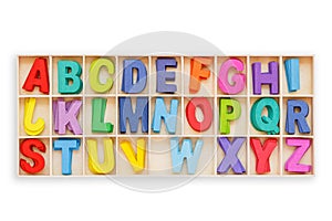 Colorful wooden alphabet in square box. Top view. Isolated on white. Saved with clipping path