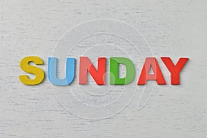 Colorful wooden alphabet with text SUNDAY. A happy Sunday concept