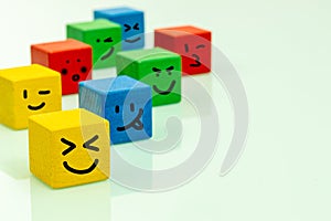 Colorful wooden blocks with emoticons Positive emotions, smiles, facial expressions, Concept of positive thinking and expressing