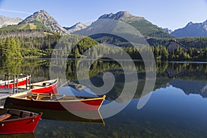 Colorful wooden boat on mountain lake . Strbske Pleso. Slovakia
