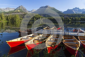 Colorful wooden boat on the mountain lake . Strbske Pleso. Slov