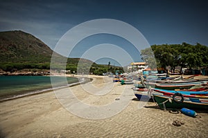 Colorful wooden boats on a beach photo