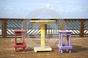 Colorful wooden chairs and table in a tropical environment