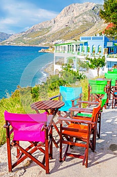 Colorful wooden chairs with view on sea, Greece