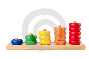 Colorful wooden children toy scores from one to five figures of the colored rings isolated on a white background. Studio shot.