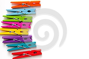 Colorful wooden clothespins on white background with copy space/diversity concept