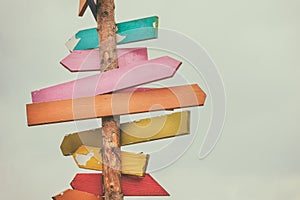 Colorful wooden direction arrow signs