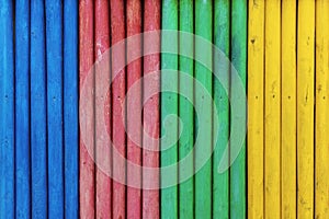 Colorful wooden fence painted in blue, red, green and yellow colorsÃÅ½