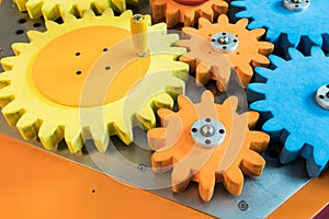 Colorful wooden gears with twisting bar for kid activity and lea