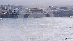 Colorful wooden houses on piles or pillars, Old Fisherman's Wharf, Monterey bay.