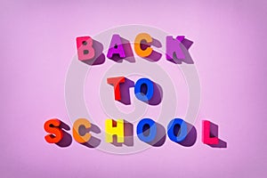 Colorful wooden latters phrase `BACK TO SCHOOL`.