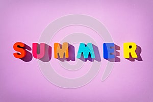 Colorful wooden letters phrase SUMMER.