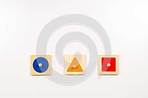 Colorful wooden Montessori sensorial material learning educational toys on white background. Geometric shape sorting photo