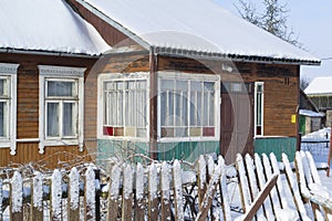 Colorful wooden old house in Belarus winter time