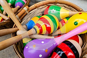Colorful wooden rattles in a basket on the market for handmade souvenirs in Tryavna, Bulgaria. Maracas for baby toy