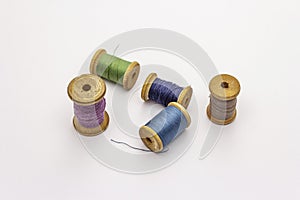 Colorful wooden spools of thread isolated on white background. Tool for sewing, handmade, craft, profession. Needlework, DIY