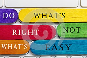 Colorful wooden sticks with word on a white keyboard. Motivational quote.