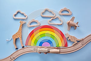 Colorful wooden toys background with rainbow. Preschool, childhood. Zero waste concept.