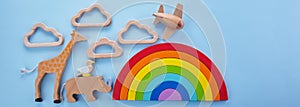 Colorful wooden toys background with rainbow. Preschool, childhood. Zero waste concept.