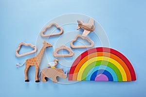 Colorful wooden toys background with rainbow. Preschool, childhood. Zero waste concept.