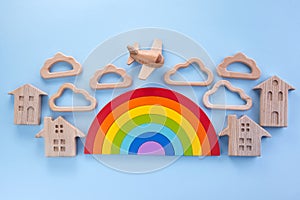 Colorful wooden toys background with rainbow. Preschool, childhood. Zero waste concept.