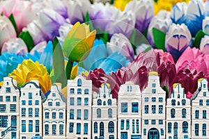 Wooden tulips with small souvenir Amsterdam canal houses