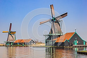 Colorful wooden windmills at the Zaan river in Zaanse Schans photo