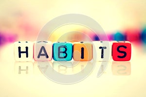 colorful word cube of habits on white background , vintage color