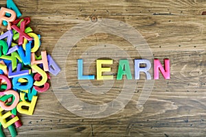 The colorful word `LEARN` next to a pile of other letters