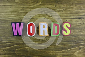 The colorful word `Words` over the wooden board.
