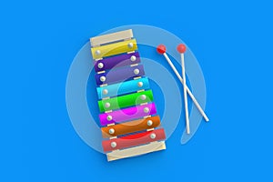 Colorful xylophone and sticks on blue background. Kids toy. Preschool education. Musical instrument