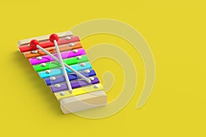 Colorful xylophone on yellow background. Kids toy. Preschool education