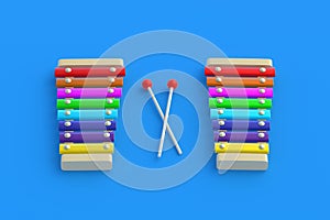 Colorful xylophones and sticks on blue background. Kids toy