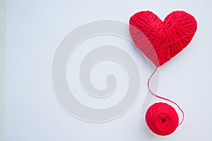 Colorful yarn ball isolated on white background. Space for text. Red heart like a symbol of love. Hobby concept