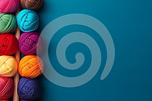 Colorful yarn balls composition on blue background, for knitting and craft projects. Copy space