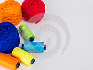 Colorful Yarn Balls and Thread Spools on a Bright White Surface